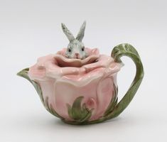 a ceramic teapot with a rabbit in it