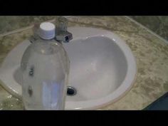 a bottle of water sitting on top of a sink