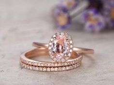 two wedding rings with an oval morganite and diamond band