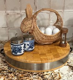 a basket filled with eggs sitting on top of a cutting board next to an egg holder