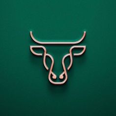 a metal bull head on a green background