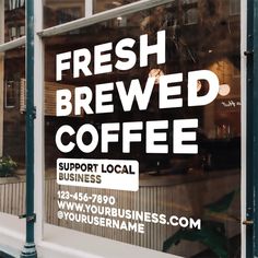 a store front window with a sign that says fresh, brewed coffee support local businesses