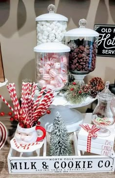 a table topped with lots of candy and candies next to a sign that says milk & cookie co