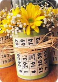 two yellow flowers are in a green bucket with numbers on it and tied to the side