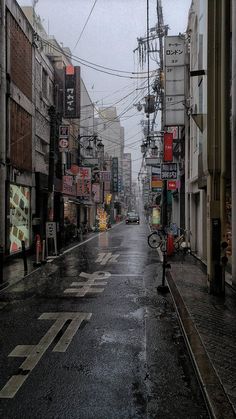 an empty city street is shown in the rain