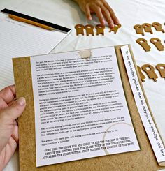 someone is cutting out letters on top of a piece of paper