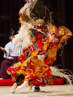 two people in costume performing on stage