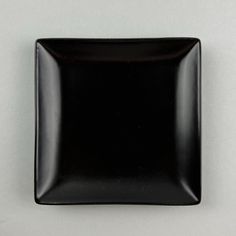 a square black plate sitting on top of a table