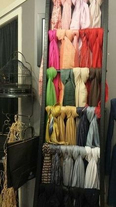 there are many scarves on display in this room and one is hanging from the wall