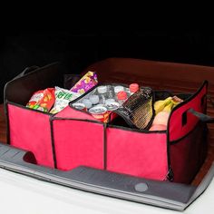 an open laptop computer sitting on top of a wooden box filled with food and drinks