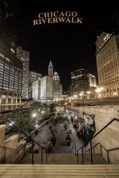 the chicago riverwalk is lit up at night