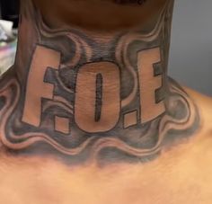 a man with a tattoo on his neck has the word off written in white ink