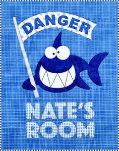 a blue and white striped towel with a cartoon shark holding a sign that says danger