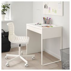 a white desk with a chair next to it