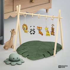 a wooden swing with animals hanging from it's sides next to a green leaf