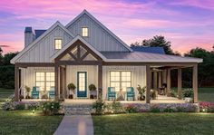 a white house with blue chairs and flowers in front of it at dusk or dawn