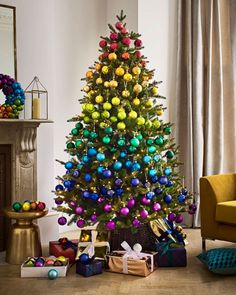 the christmas tree is decorated with colorful ornaments