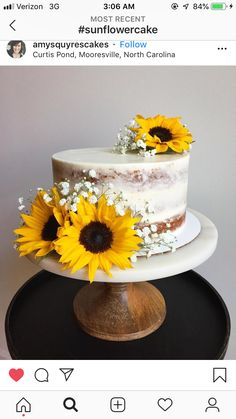 the cake is decorated with sunflowers and white frosting on it's top