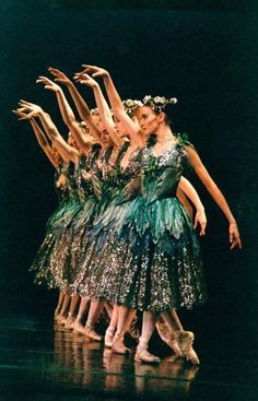 a group of ballerinas standing on top of each other