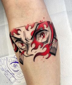 a close up of a person's leg with a tattoo on it and red eyes