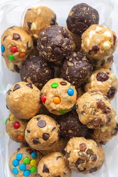 a plastic container filled with lots of cookies and chocolates on top of each other