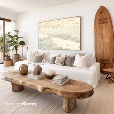 a living room filled with furniture and a surfboard hanging on the wall above it