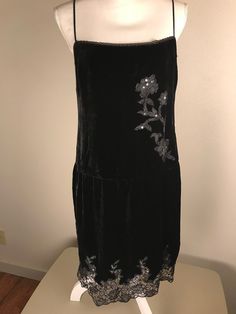 A very pretty Betsey Johnson black velvet evening dress with lace and sequins. It is sleeveless with adjustable spaghetti straps and a side zipper. A beautiful lace with sequins design graces the front and the hem line. It is a size 10.  It is in very good preowned condition. Measurements are taken with garment laying flat.  17 inches underarm to underarm  17 inches across waist line  20 inches across hip line  29 inches length from top of bodice to hem. Please check measurements carefully as I Black Velvet Holiday Evening Dress, Black Velvet Evening Dress For Holidays, Sleeveless Velvet Evening Dress For Night Out, Sequined Velvet Evening Dress, Black Velvet Sequin Dress, Elegant Sequined Velvet Dress, Party Velvet Dress With Lace Trim, Velvet Lace Trim Dress For Party, Velvet Dress With Lace Trim For Party