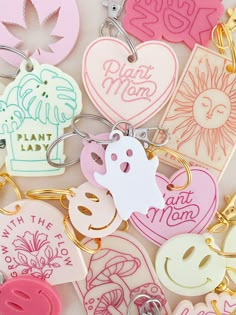 many different key chains with various designs and words on them, including the word plant mom