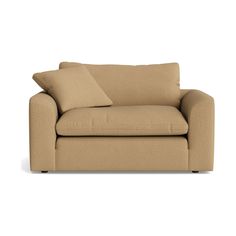 a beige couch with two pillows on the back and one arm folded up in front