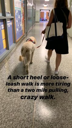 a woman walking a dog down a hallway with a quote on the wall behind her