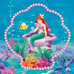 the little mermaid is sitting on an ocean bed