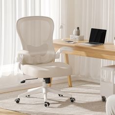 a white office chair sitting in front of a desk with a laptop computer on it