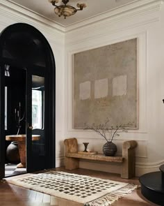 an image of a living room with black and white decor on the walls, windows, and rugs