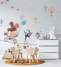 a child's room with balloons and animals on the wall