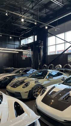 there are many different sports cars in this garage