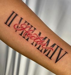 a man's arm with the word tattoo on it and his name written in red ink