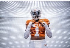 a football player wearing an orange and white uniform