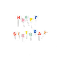 the words happy birthday are spelled out with colorful cake toppers on white paper sticks