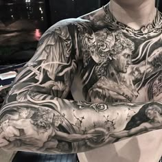 an image of a man with tattoos on his arm and chest, in the middle of twitter