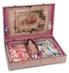 an open suitcase with dolls in it