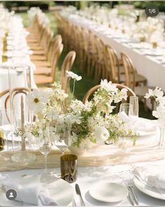 the table is set with white flowers and place settings for guests to sit down at