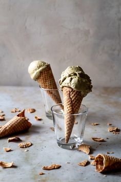 two ice cream cones sitting on top of a table