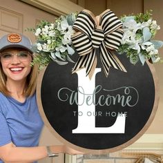 a woman standing next to a welcome sign