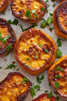 baked tomatoes with cheese and herbs on a sheet of parchment paper, ready to be eaten