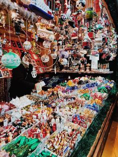 a large assortment of christmas ornaments in a store