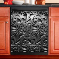 an ornate design is shown on the front door of a kitchen cabinet with red cupboards