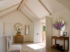 a living room with white walls and wooden floors