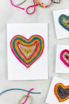 four cards with different colored hearts on them and some string attached to the back of each card