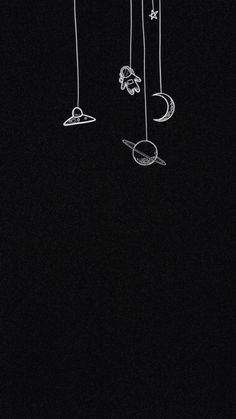 a drawing of the moon, stars and planets hanging from strings on a black background