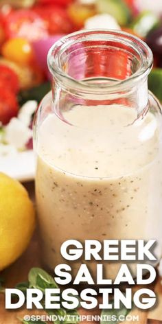 greek salad dressing in a glass jar on a cutting board